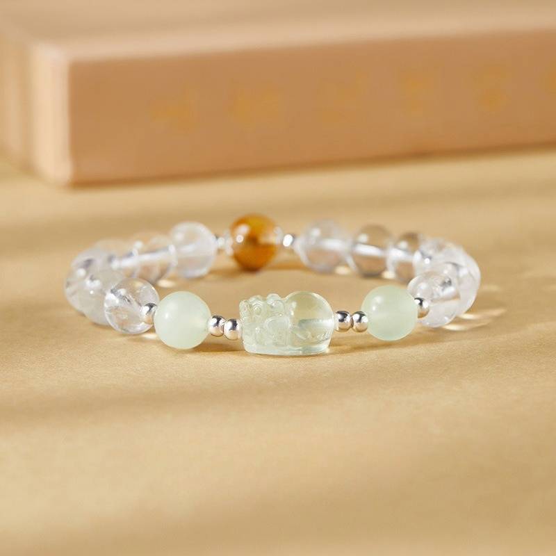 Wealth Guardian Pixiu White Crystal Bracelet - Fortune & Abundance - shot focus on carved lemon quartz Pixiu