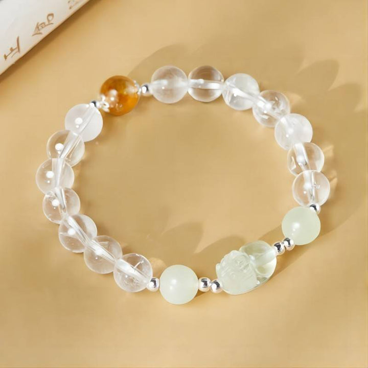 Wealth Guardian Pixiu White Crystal Bracelet - Fortune &amp; Abundance - top view prop-styled shot