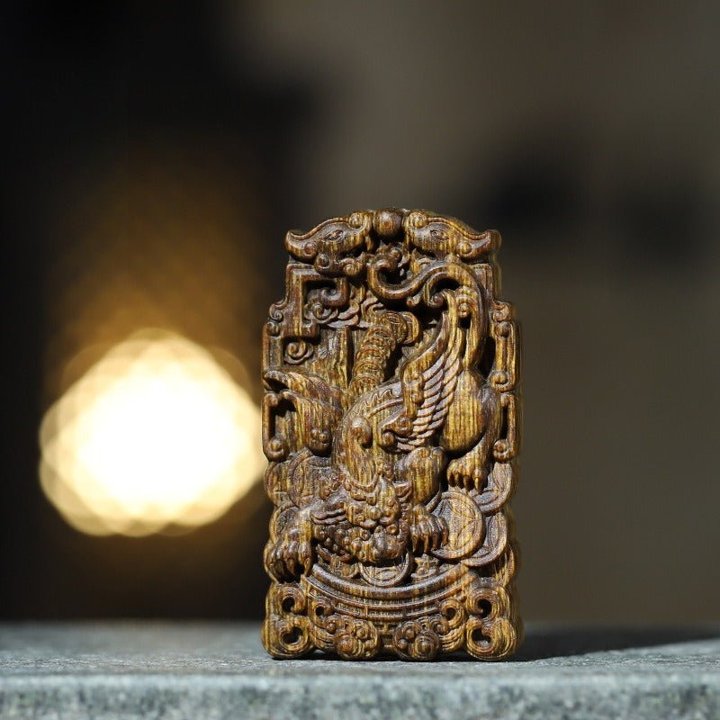 Wealth Guardian Winged Pixiu Pendant - Protection & Celestial Blessing - fist front view of the agarwood pendant