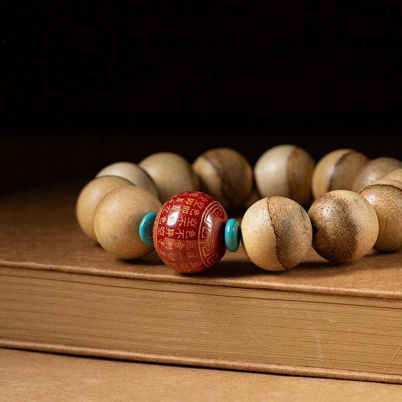 Wisdom & Protection Heart Sutra Mantra Sandalwood Bracelet - close up shot of master bead